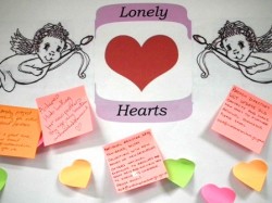A noticeboard entitled Lonely Hearts with cupid illustrations and post it notes