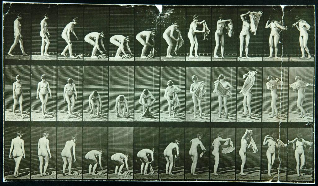 An example of early photography from 1887, 'Female lifting cloth from the ground, placing it around shoulders and turning' by Eadweard Muybridge. COPY 1/385 pt2 (227). 