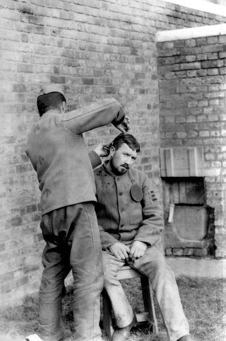 'Photograph interior Wormwood Scrubs Prison cutting hair of prisoner' (catalogue reference: COPY 1/420/169)