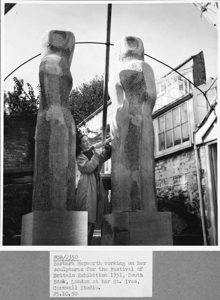 A photograph showing Barbara Hepworth working on a sculpture.