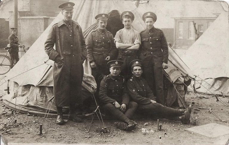 Image of Daniel and five other soldiers in front of a tent at Aldershot training camp