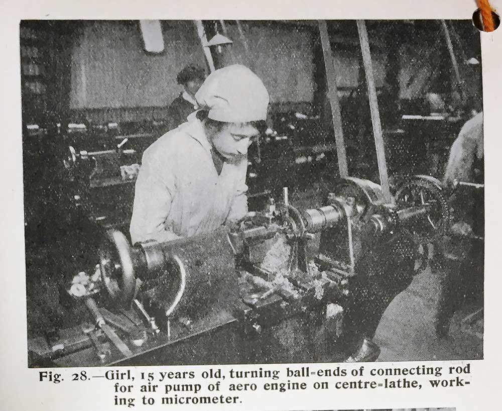 Image of a girl turning ball ends of connecting rod for air pump of aero engine on centre-lathe 