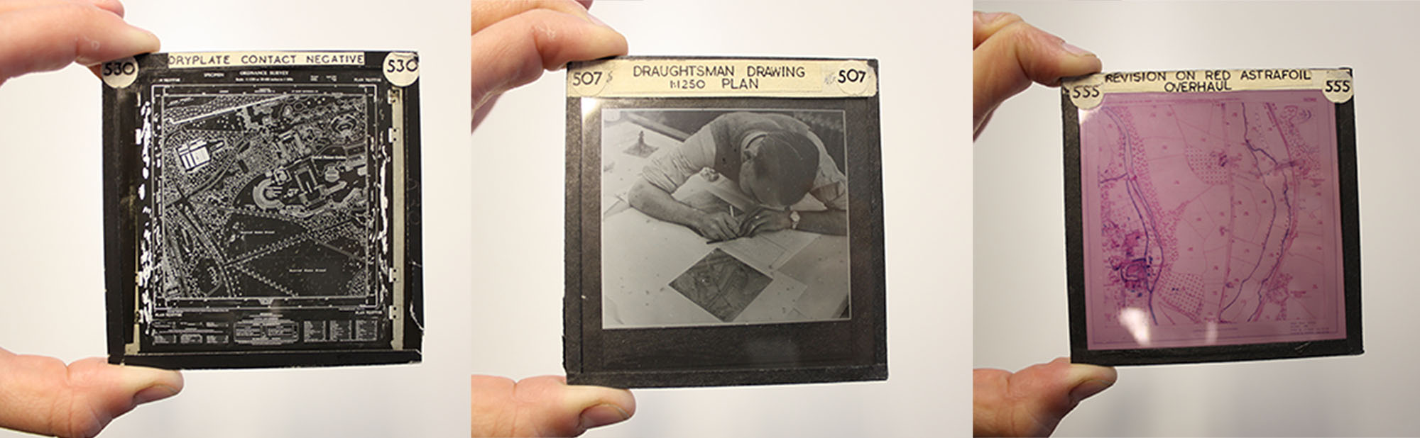 Composite image of three lantern slides being held up; one depicts an aerial photograph, another a person writing 