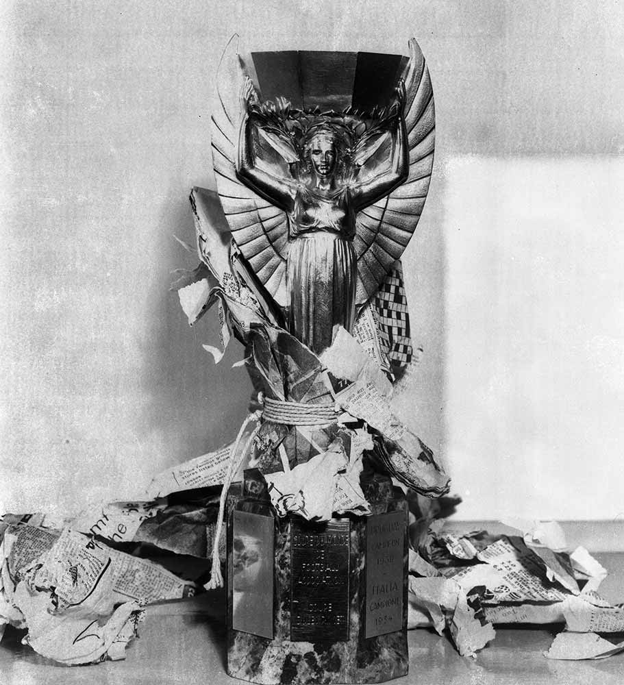 Image of the Jules Rimet Trophy with a newspaper wrapping torn off 