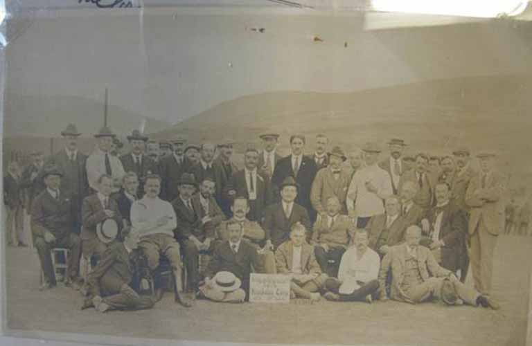 Photograph of a group of men, some sitting and some standing