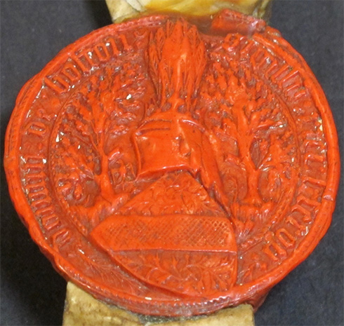 Armorial seal of Sir Richard Lord Scrope of Bolton, dated 1399. The armorial shield here is elaborately stylised with a pattern of foliage on either side of a crosshatched bend. The livery colours would have been the same as the shield of arms in the dispute with Sir Robert Grosvenor: an azure background with a gold bend. (catalogue reference: E 42/4).