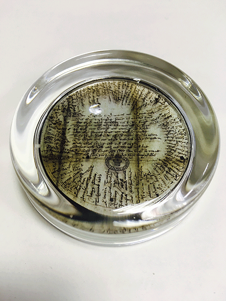 This glass paperweight shows an image of an early and rare example (circa 1627) of a sailor's 'round robin' addressed to a Captain of one of the King's ships.