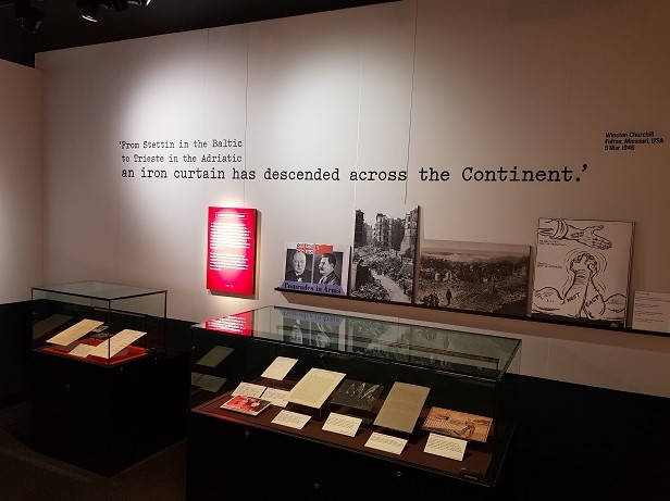 Two document showcases are shown in the section of the exhibition entitled 'A new conflict emerges'. The famous quotation from Winston Churchill is displayed on the wall above: 'From Stettin in the Baltic to Trieste in the Adriatic an iron curtain has descended across the Continent'. This was part of a speech made by Churchill at Fulton, Missouri, USA, on 5 Mar 1946 