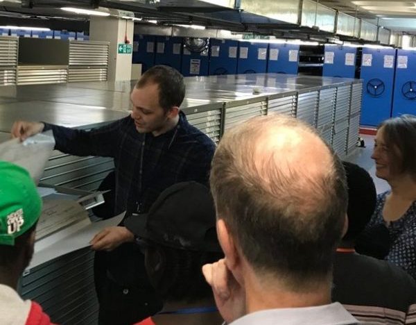 The students being shown documents in the repository at The National Archives.
