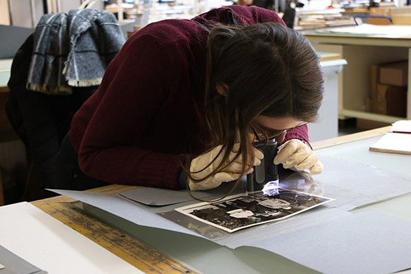 Young woman examining a photograph