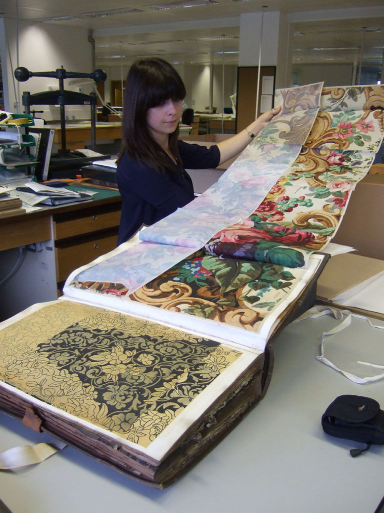 Conservator looking at a BT design register.