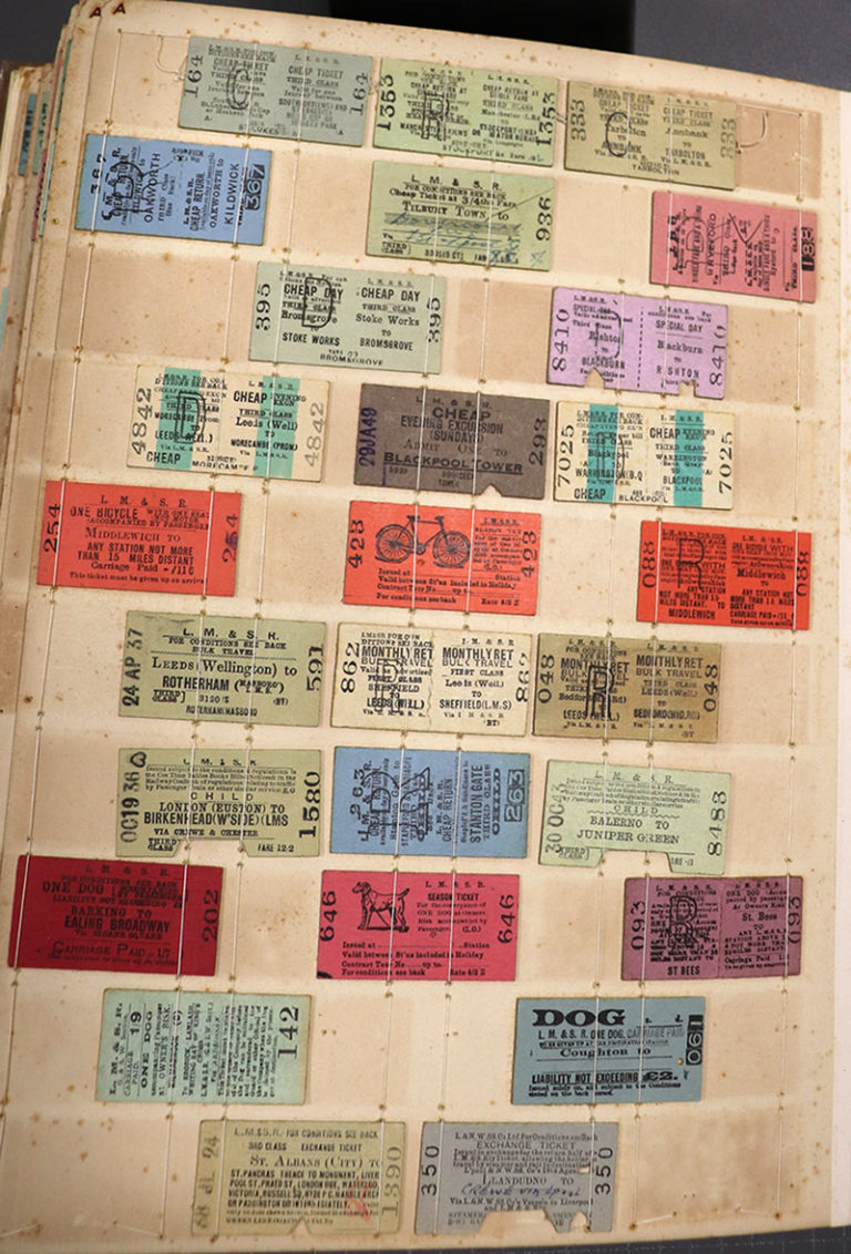 A page from a binder containing ten rows of train tickets for various destinations in the UK. Tickets are about one by two inches in size, different colours, some with images of a dog or a bicycle.