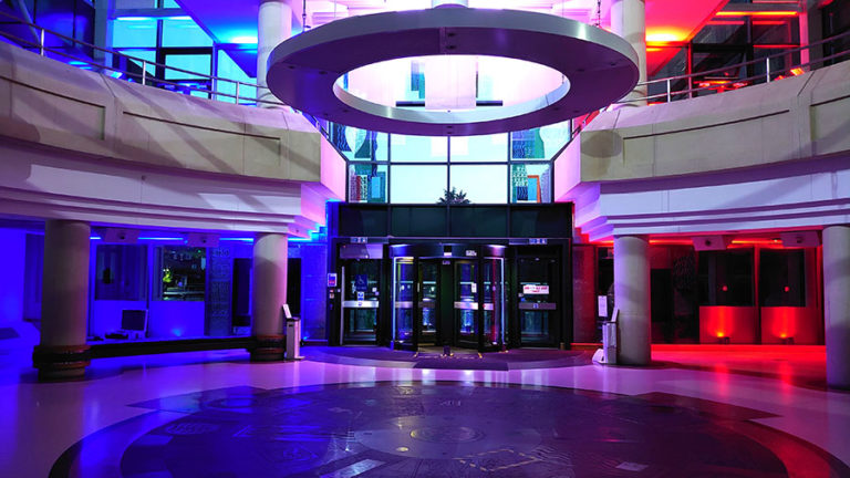 Colour photograph of the entrance to The National Archives lit up to celebrate VE Day.