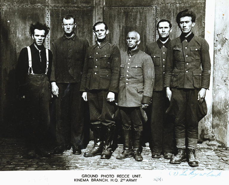 A British 2nd Army reconnaissance unit photograph of six of the 45 defendants of the Bergen-Belsen Trial in May/June 1945. These men, who had served as SS camp guards at the Bergen-Belsen Transit Camp and Auschwitz Concentration Camp, include an Unterscharführer named Joachim Wolf (third man standing from left) who assisted in the murder of Able Seaman Keith Mayor.