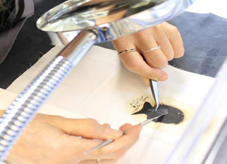 Conservator treating a miniature silhouette portrait dating from 1780.