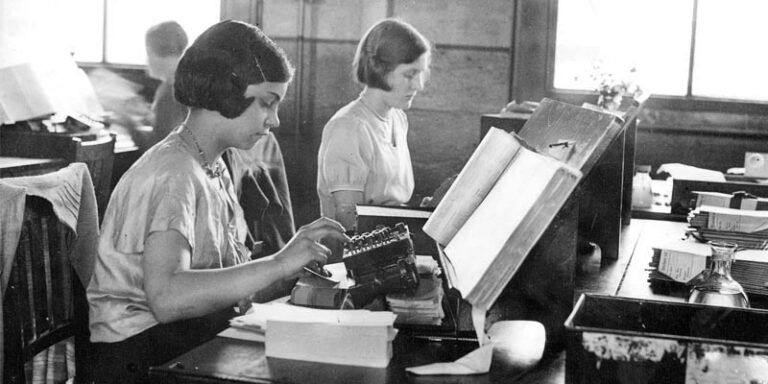 Publicity photograph showing punching of machine cards for the 1931 census at the Census Office in Acton. The photograph shows two young women at work in the office.