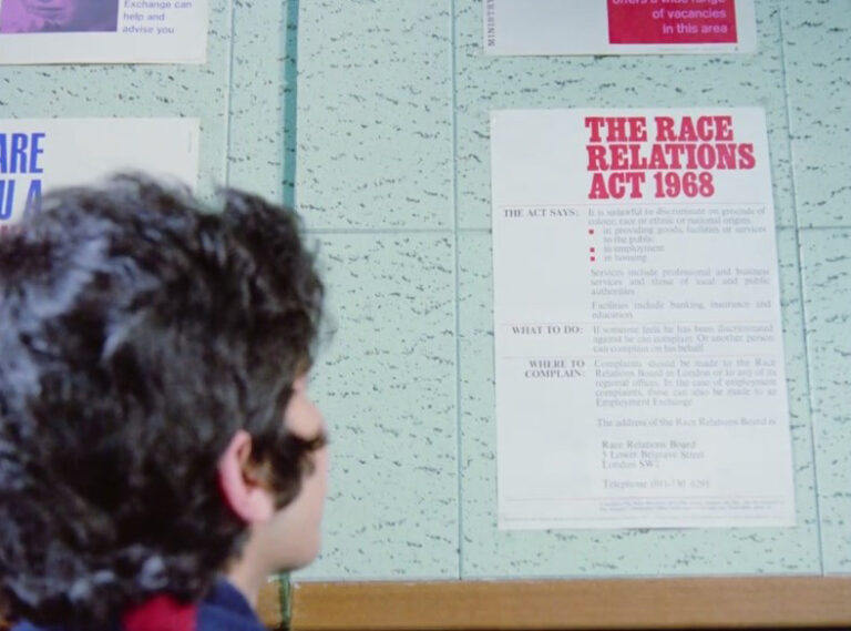 Still from 'Insaaf': Chhotu sees a poster about the Race Relations Act.