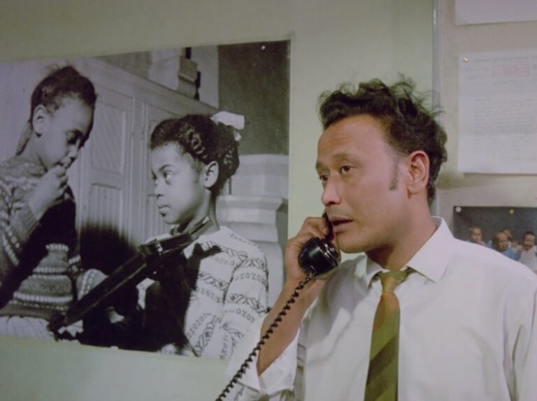 Still from 'Insaaf': Dilip Kapoor of the Race Relations Board telephoning Mr Appleby.