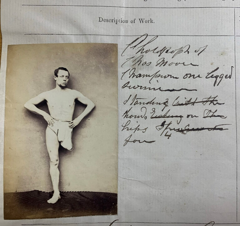 Photograph of Charles Moore, champion one legged swimmer, standing hands on hips, ¾ face.