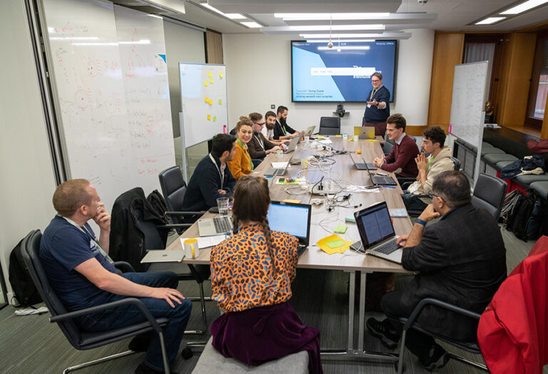 Participants sitting around a table.