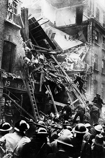 Fire services, Police, ARP Rescue Services and Medical Orderlies working together at a bomb-damaged building, 1940-1945.