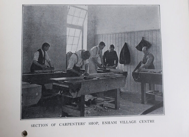 Five men shown working in the carpenters' shop at Enham Village Centre.