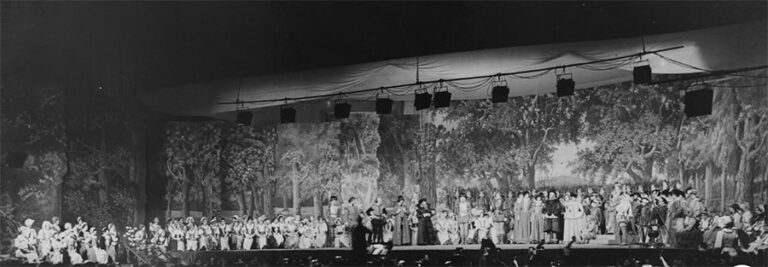 A cast of actors and performers on stage at Alexandra Palace.
