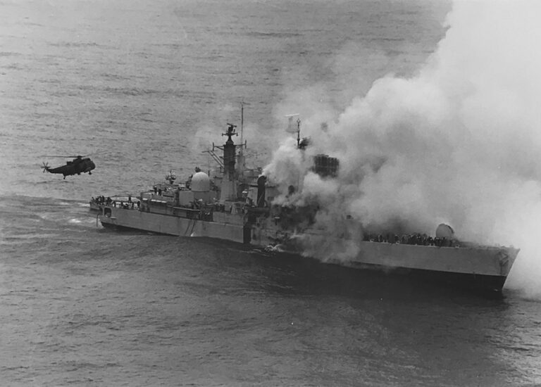 Smoke pours out of HMS Sheffield after it has been hit by enemy fire.