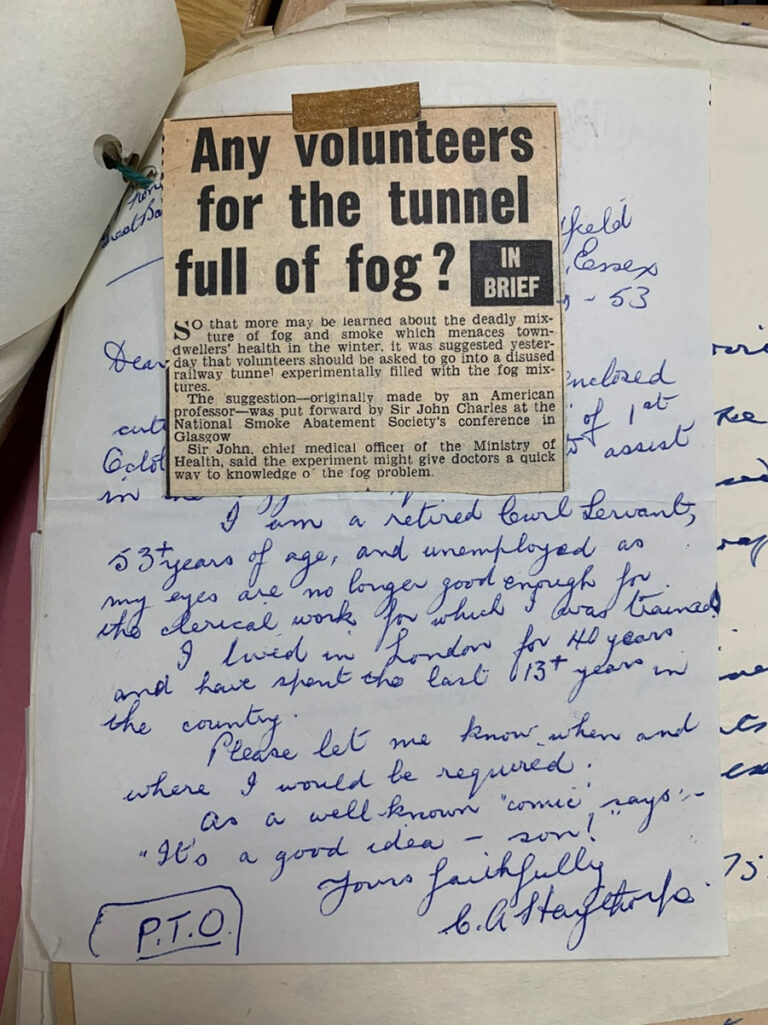 A handwritten letter which is part obscured by a newspaper cutting with the headline 'Any volunteers for the tunnel full of fog?'.