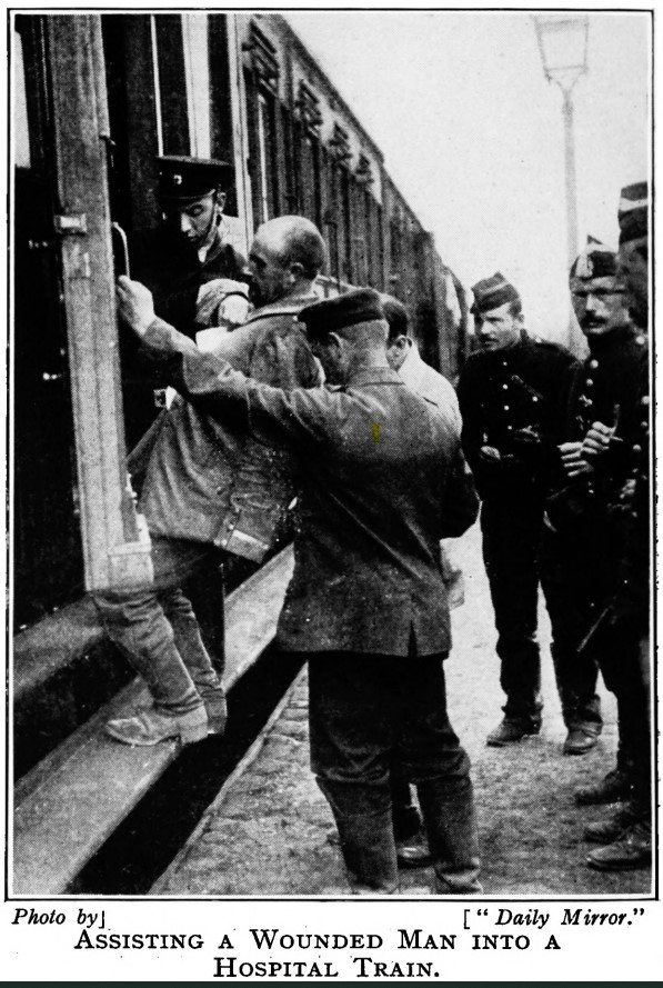 Three men help another man on to a train.