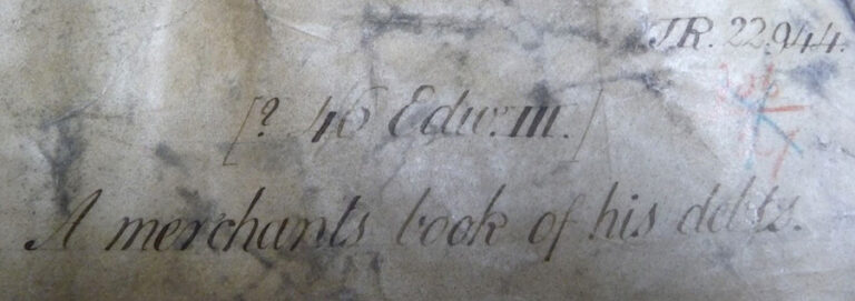 Small segment of a document with some faint handwritten text.