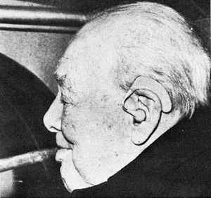 Headshot of Winston Churchill smoking a cigar. He wears a hearing aid in his left ear.