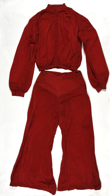 Matching long-sleeved top and trousers, both red, described at a lounge suit. 