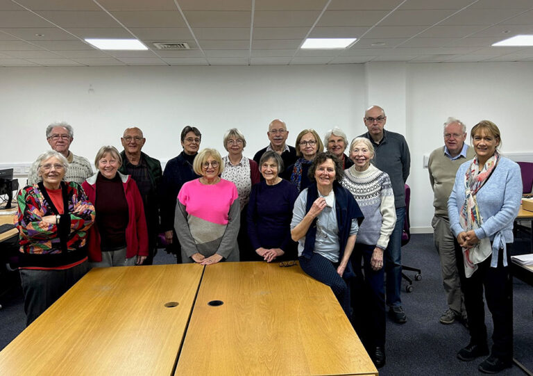 A group of volunteers smile at the camera. 