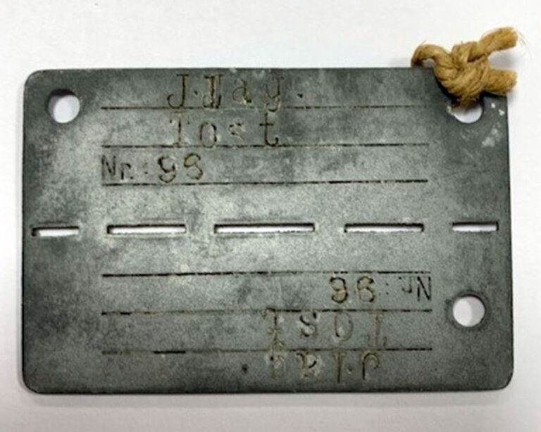 A rectangular metal tag. 