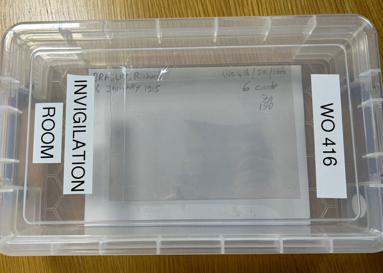 A small plastic box labelled 'invigilation room' inside is a record card. 
