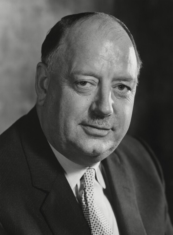 Photo portrait of a man with a faint smile.