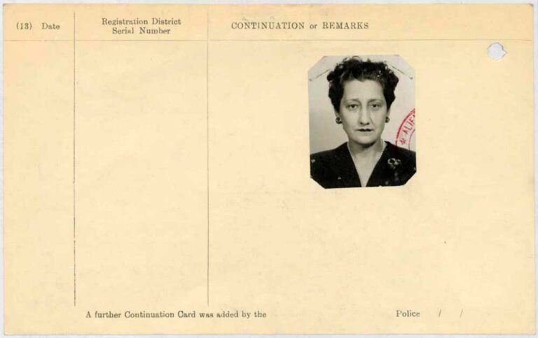 A yellow continuation page. There is no information on the page other than a small black and white photo of a middle aged woman in a black jacket