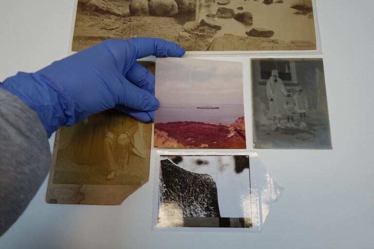 Someone handling photographic material while wearing nitrile gloves.