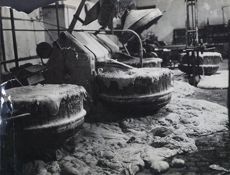 A black-and-white photograph showing wasted dough after a strike at a bakery. 
