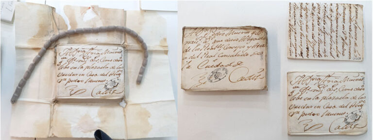 An old letter that has been opened to reveal another letter folded up within. 