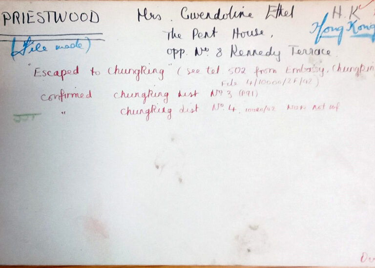 An index card with handwritten notes on it. The notes are written at different times and in different colours: red, black and blue. There are dates and the name Priestwood written. 