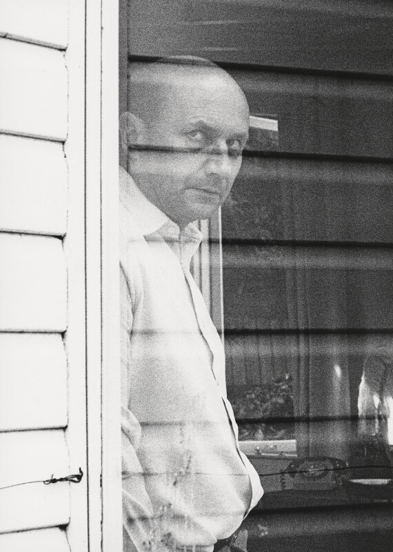 Donald Pleasence looking out of a window. 