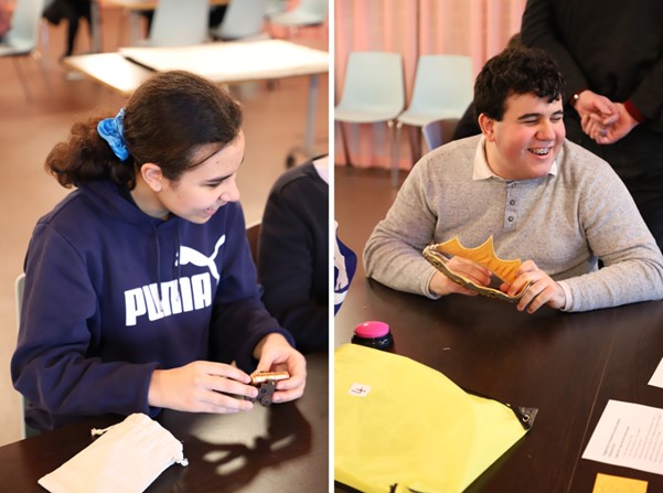 Two images side by side. On the left, a student laughs while holding a small model of a cannon. On the right, a student laughs while holding a crown made out of fabric.