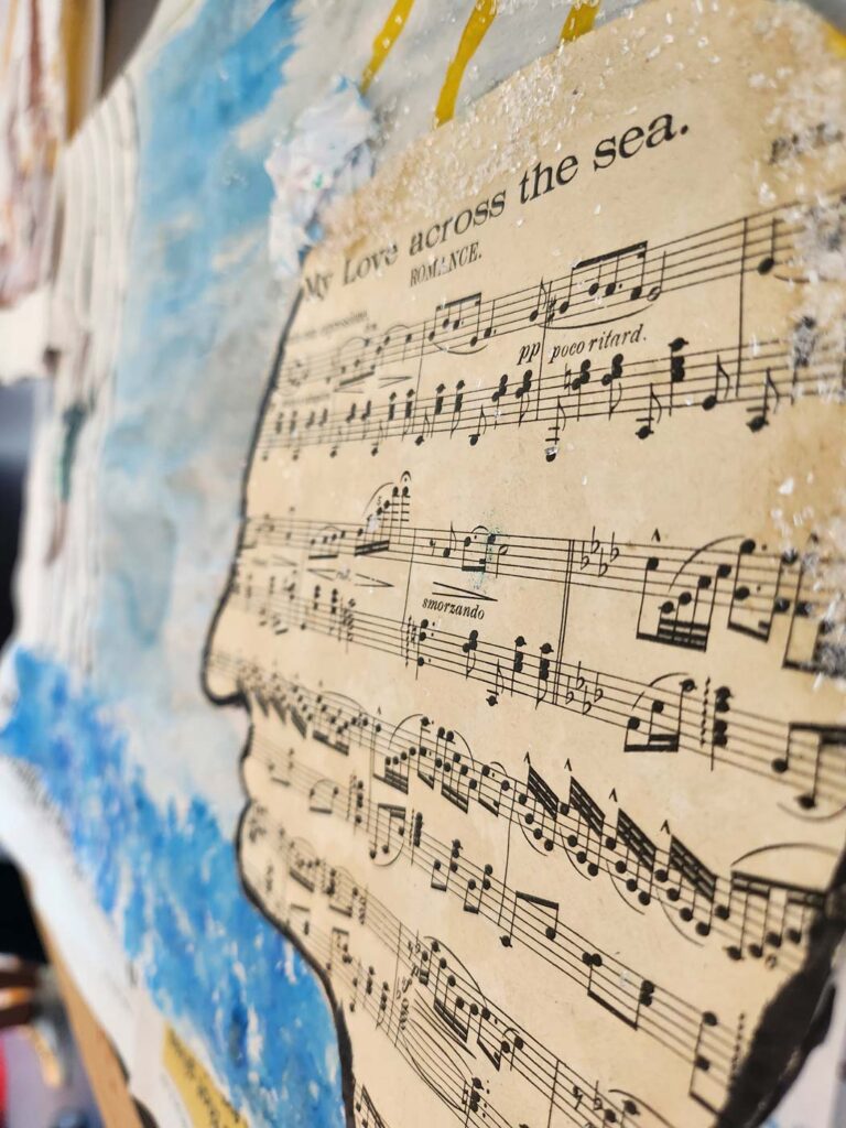 A piece of artwork created during a creative workshop at The National Archives. It's collage piece featuring a sheet of music titled 'My love across the sea'. 