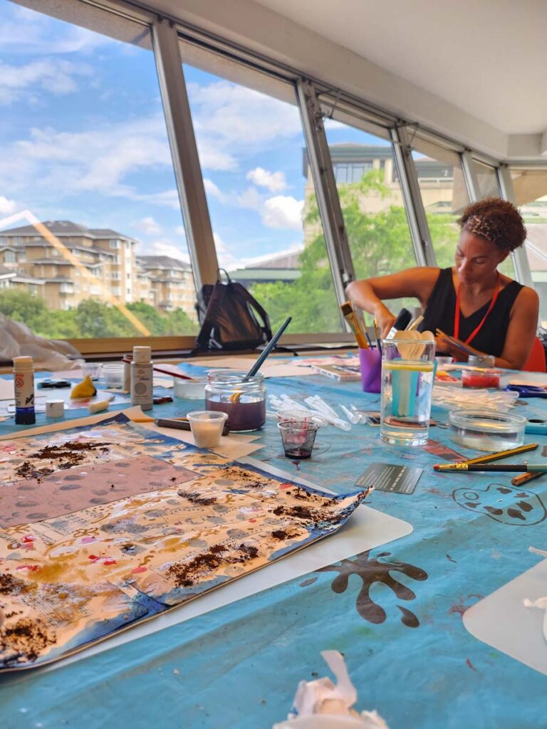 Someone photographed working on a piece of artwork as part of a creative workshop at The National Archives.