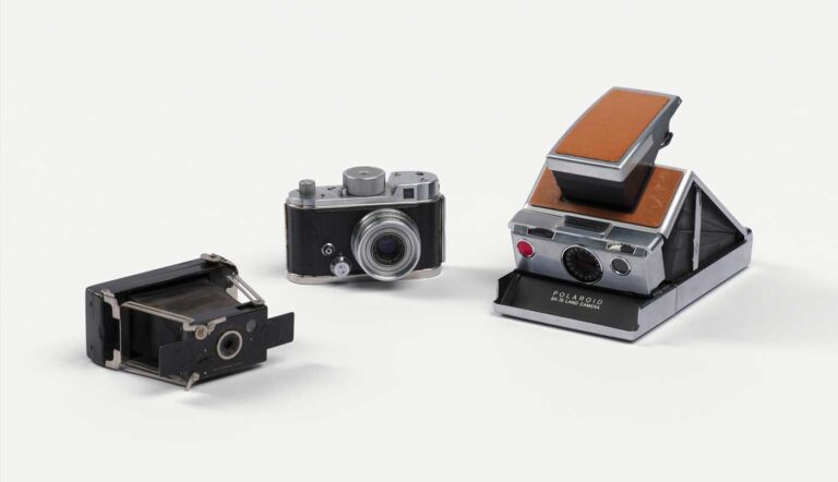 Three cameras photographed against a white backdrop, each very different in shape and size.